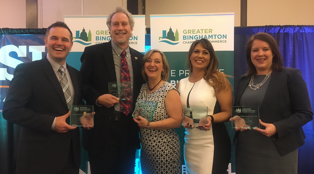 Recipients of the Chamber of Commerce's Spring Awards holding glass trophies